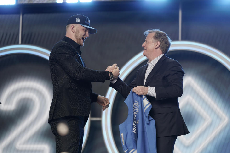 Michigan defensive end Aidan Hutchinson shakes hands with NFL Commissioner Roger Goodell after being selected by the Detroit Lions as the second pick in the NFL football draft Thursday, April 28, 2022, in Las Vegas. (AP Photo/Jae C. Hong )