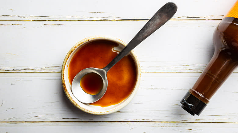 Worcestershire sauce in a bowl with bottle on the side