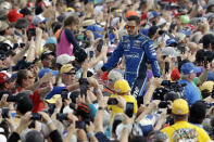 FILE - Kyle Larson greets fans before the NASCAR Daytona 500 auto race at Daytona International Speedway in Daytona Beach, Fla., Sunday, Feb. 16, 2020. Larson is a fan favorite and represents the kind of grass roots racer NASCAR fans have long embraced. (AP Photo/Chris O'Meara, File)