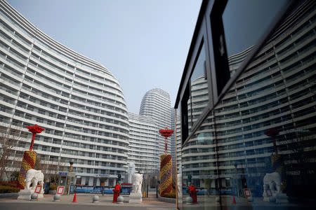 A security officer guards an entrance of a luxury apartment complex built and offered for sale on the Moon Island on the Yalu River, in Dandong, China's Liaoning province, March 30, 2017. REUTERS/Damir Sagolj