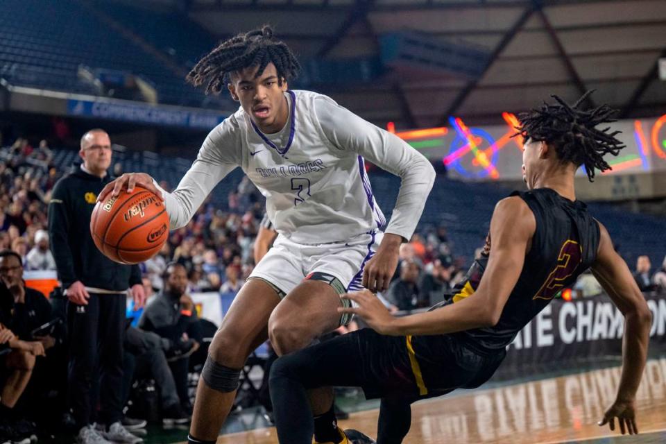 O’Dea guard Mason Williams (2) draws a charge on Garfield forward Jaylin Stewart (3) as he drives toward the baseline during the first quarter of the Class 3A championship game on Saturday, March 4, 2023, in Tacoma, Wash.