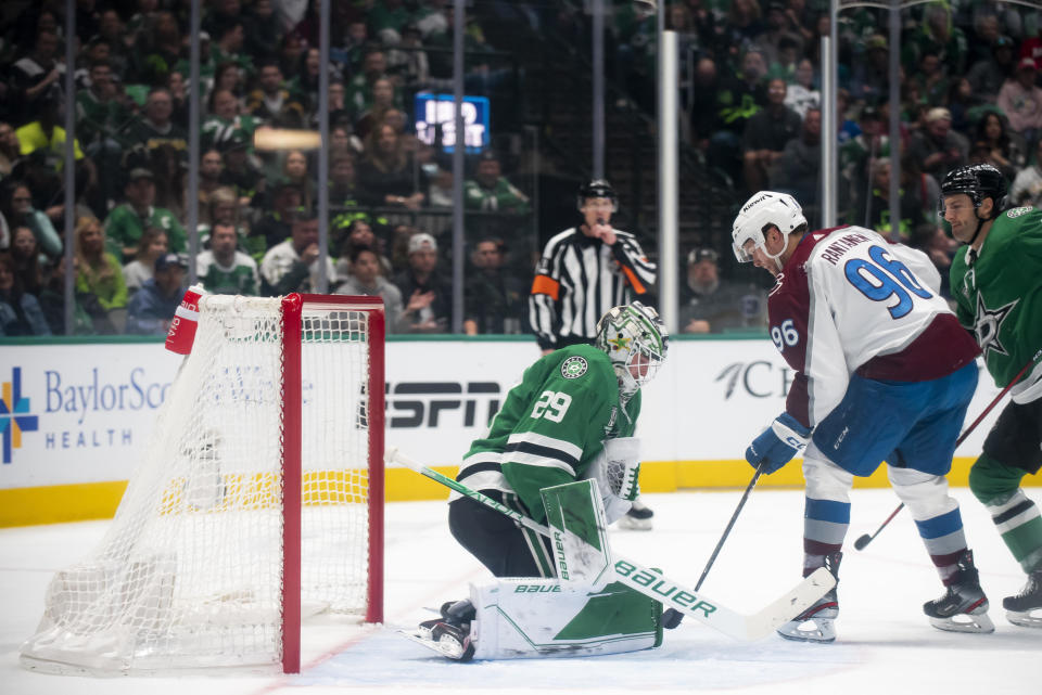 Dallas Stars goaltender Jake Oettinger (29) stops a shot by Colorado Avalanche right wing Mikko Rantanen (96) during the second period of an NHL hockey game, Saturday, March 4, 2023, in Dallas. (AP Photo/Emil T. Lippe)