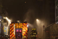 Firefighters battle a fire at a construction site in Hong Kong, Friday, March 3, 2023. Hong Kong firefighters are battling the blaze that broke out at a construction site in the city's popular shopping district. (AP Photo/Louise Delmotte)