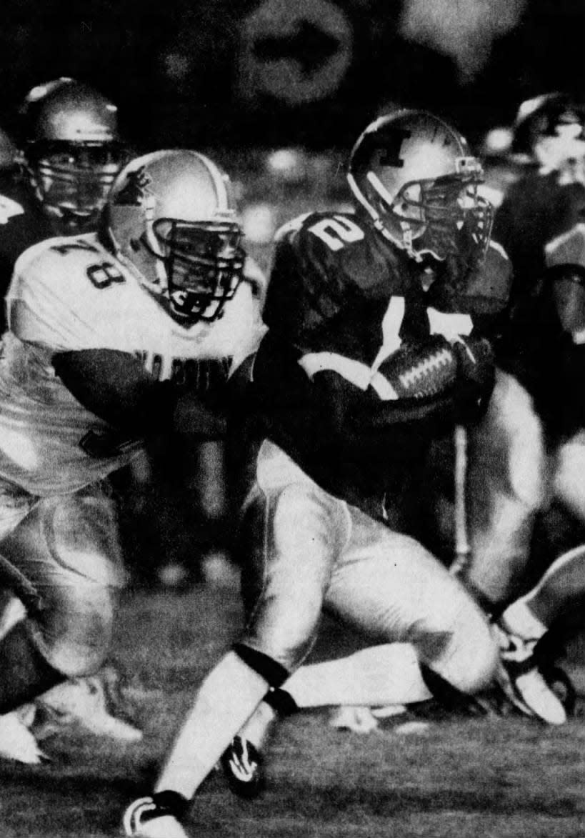 Hillsborough quarterback Jared Jones breaks free from Old Bridge’s Joe Maglaqui (78) for a first down in the first half. Jones gained 122 yards on the ground on Friday, Sept. 11, 1998.