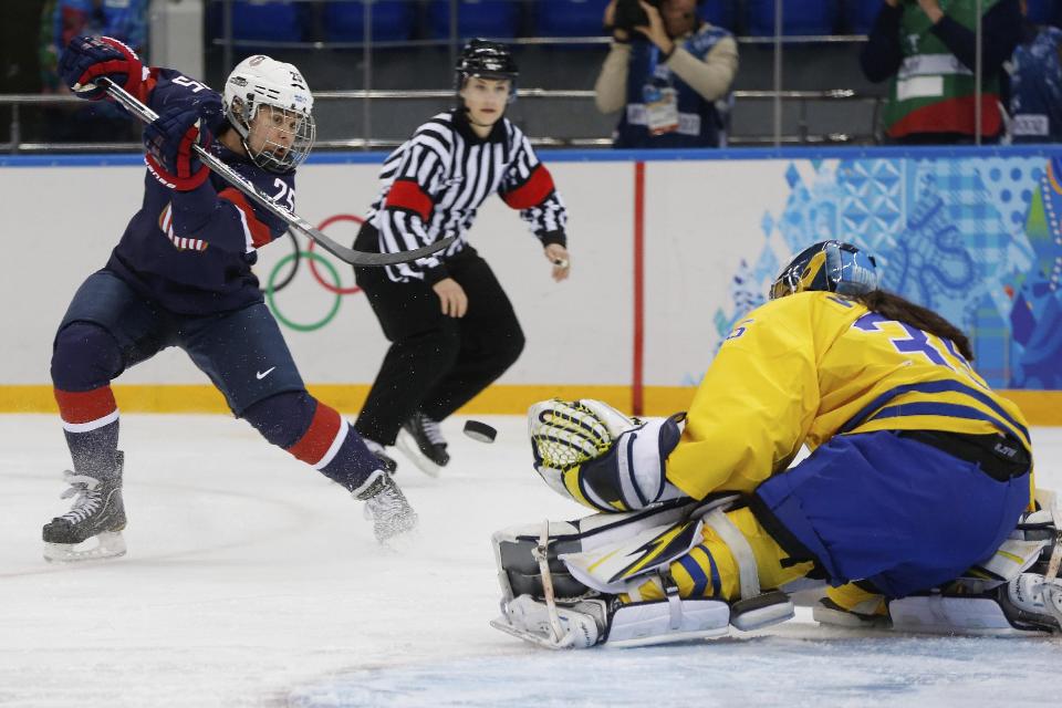 Alex Carpenter of the United States shoots on goalkeeper Valentina Wallner of Sweden during the first period of the 2014 Winter Olympics women's semifinal ice hockey game at Shayba Arena Monday, Feb. 17, 2014, in Sochi, Russia. (AP Photo/Petr David Josek)