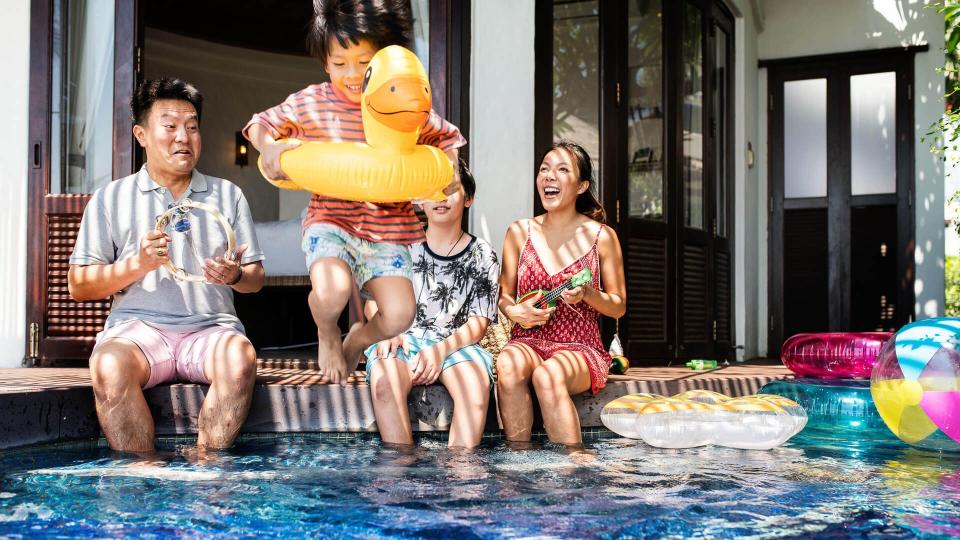 Family playing in a pool.