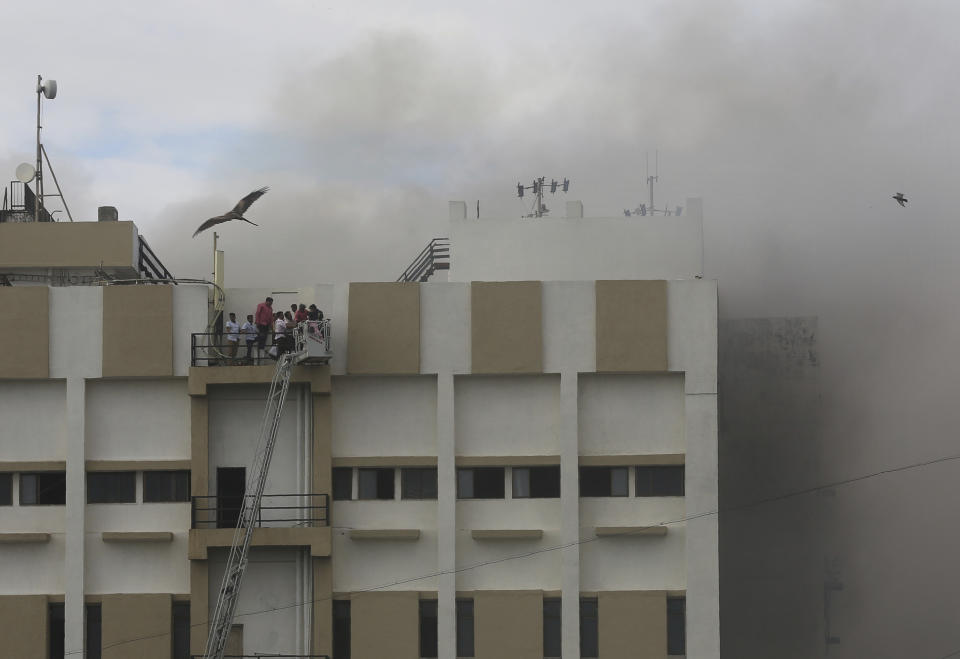 People are rescued from a nine-story building with offices of a state-run telephone company during a fire in Mumbai, India, Monday, July 22, 2019. (AP Photo/Rafiq Maqbool)