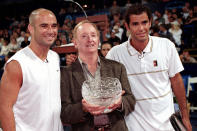 FILE - In this Monday, July 26, 1999, file photo, tennis greats Andre Agassi, left, Rod Laver, center, and Pete Sampras pause for photos after Laver was presented a silver bowl for his tennis career before a benefit tennis match in the Westwood section of Los Angeles. (AP Photo/Rene Macura File)