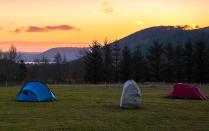 The Lake District is perfect for adventurous families, with hiking and watersports available around every corner. At the foot of Skiddaw in the north of the Lake District, <a href="https://coolcamping.com/campsites/uk/england/north-west-england/cumbria/bassenthwaite/384-kestrel-lodge-camping" rel="nofollow noopener" target="_blank" data-ylk="slk:Kestrel Lodge Camping;elm:context_link;itc:0;sec:content-canvas" class="link ">Kestrel Lodge Camping</a> is a quaint converted farmstead where campers pitch up beyond original brick barns in a flat meadow with great mountain views. Facilities include family-sized washrooms, a shop, laundry and Wi-Fi. There's a family-friendly village pub a short stroll away, and you can hire canoes at nearby Bassenthwaite Lake. Pitches for up to six people cost from £27 per night. <em>[Photo: Cool Camping]</em>