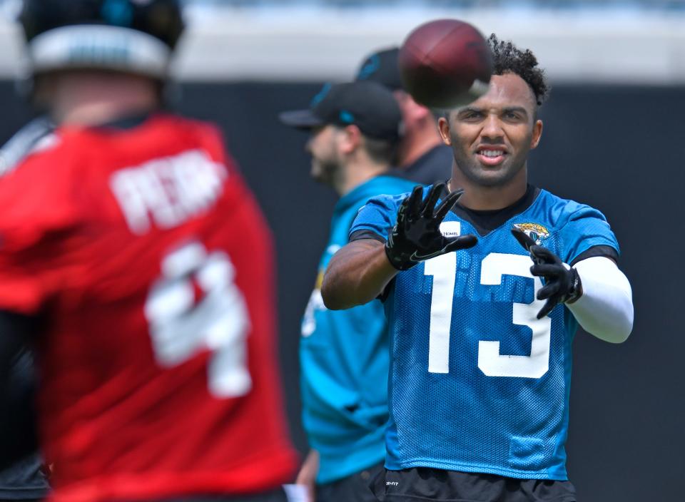 Jaguars WR Christian Kirk (13) throws the ball with quarterback (4) E.J. Perry during the Jacksonville Jaguars Organized Team Activity session at TIAA Bank Field Monday, May 23, 2022.