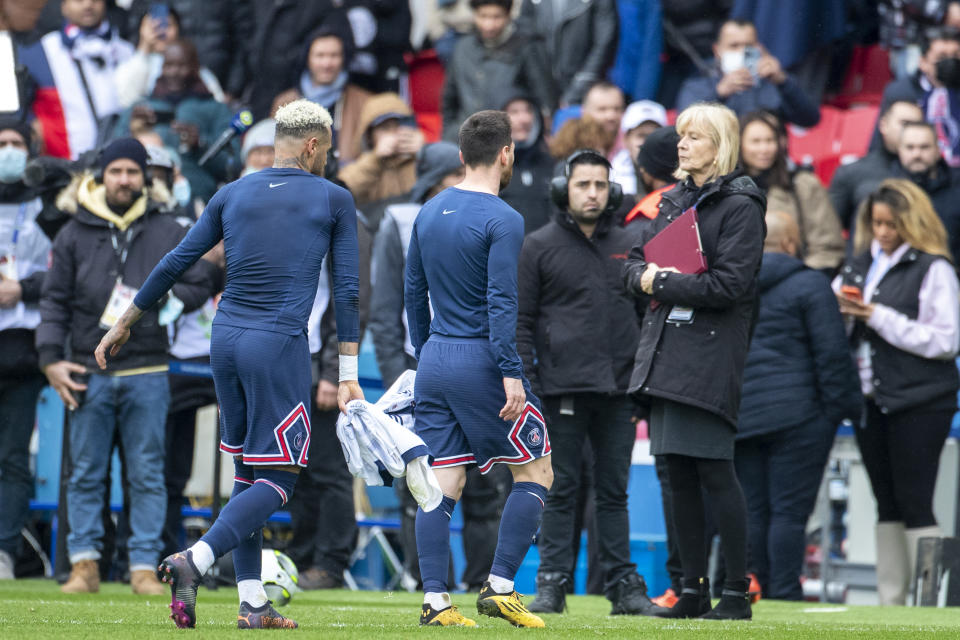 Lionel Messi (pictured right) and Neymar (pictured left) leave the field after being booed from Paris Saint-Germain fans.