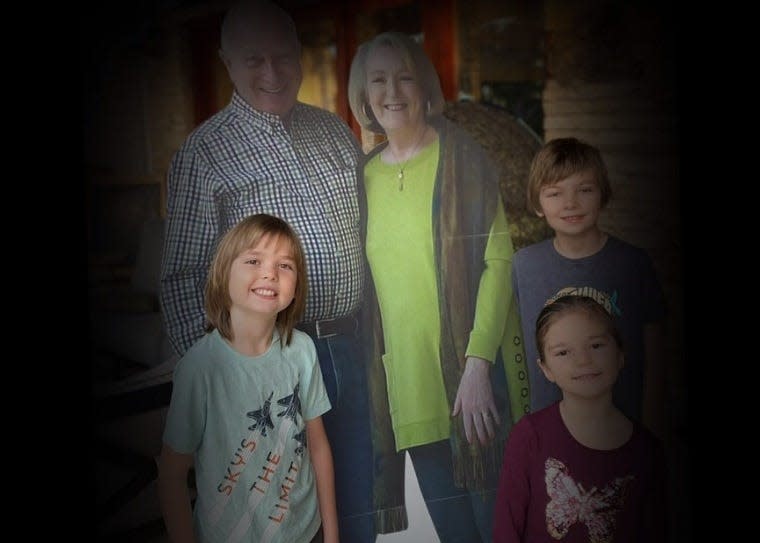 Missy and Barry Buchanan's grandchildren pose with the cardboard cutout their grandparents sent in lieu of traveling for Thanksgiving.
