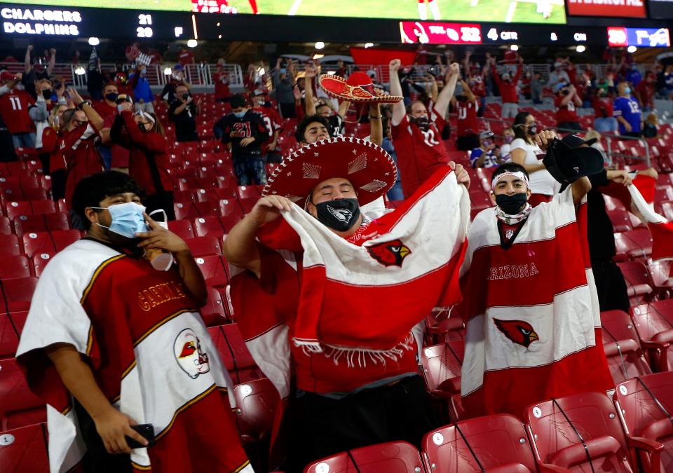 Cardinals fans celebrate as the team pulls off a Hail Mary touchdown for the win against the Bills at State Farm Stadium in Glendale, Ariz. on Nov. 15, 2020. 