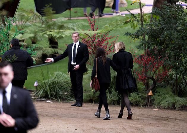 Courtney and a friend walk to the service. Source: Getty