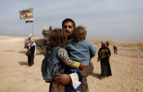 <p>Displaced Iraqis who just fled their home walk through the desert as Iraqi forces battle with Islamic State militants, in western Mosul, Iraq February 27, 2017. (Zohra Bensemra/Reuters) </p>