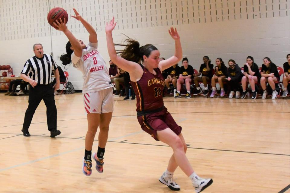 Rancocas Valley senior Adriana Agosto pulls up for a layup at Haddon Heights forward Maggie Campbell flies by