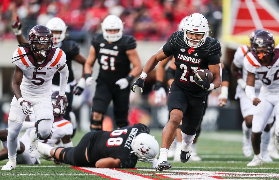 Louisville Cardinals running back Isaac Guerendo (23) breaks away for a fourth-quarter touchdown run against Virginia Tech. Guerendo had three touchdowns. Nov.4, 2023.