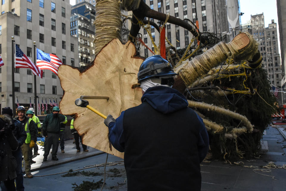 A worker drives a spike into the bottom of the Rockefeller Center tree during the installation.