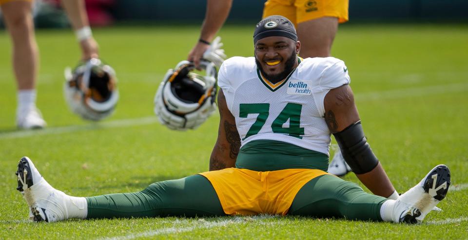 Green Bay Packers guard Elgton Jenkins stretches during practice.