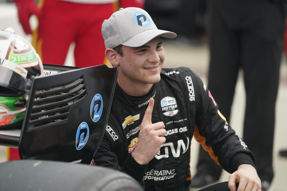 FILE - Pato O'Ward, of Mexico, smiles after winning the pole for the IndyCar auto race at Indianapolis Motor Speedway in Indianapolis, in this Friday, Aug. 13, 2021, file photo. O'Ward finished second and third at Gateway last season when IndyCar ran a doubleheader on the 1.25-mile oval, which he called his best weekend of 2020. He sliced Alex Palou's points lead in half last weekend and expects to pounce again Saturday night, Aug. 21, 2021. (AP Photo/Darron Cummings, File)