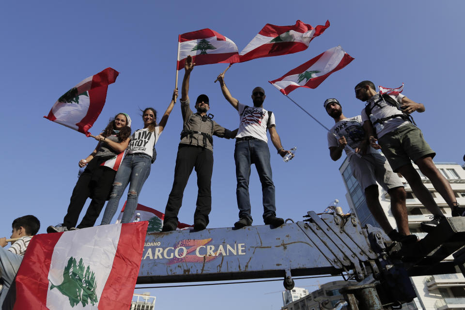 Anti-government protesters shout slogans against the Lebanese government during a protest in Beirut, Lebanon, Monday, Oct. 21, 2019. Lebanon's Cabinet approved Monday sweeping reforms that it hopes will appease thousands of people who have been protesting for five days, calling on Prime Minister Saad Hariri's government to resign. (AP Photo/Hassan Ammar)