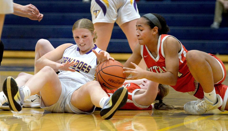 Taylorville's Grace Rogers, left, and Glenwood's Hope Gilmore fight over the ball during the 3A Girls Basketball Regional Tournament Friday, February 16, 2024.