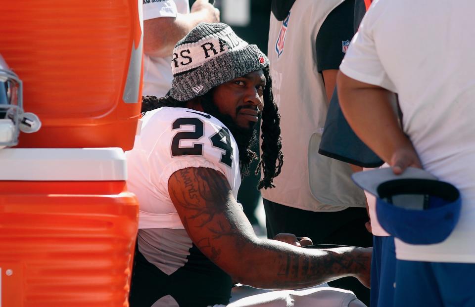 After clearly being upset on the field, Marshawn Lynch played it cool post-game when asked about a Derek Carr interception. (AP)