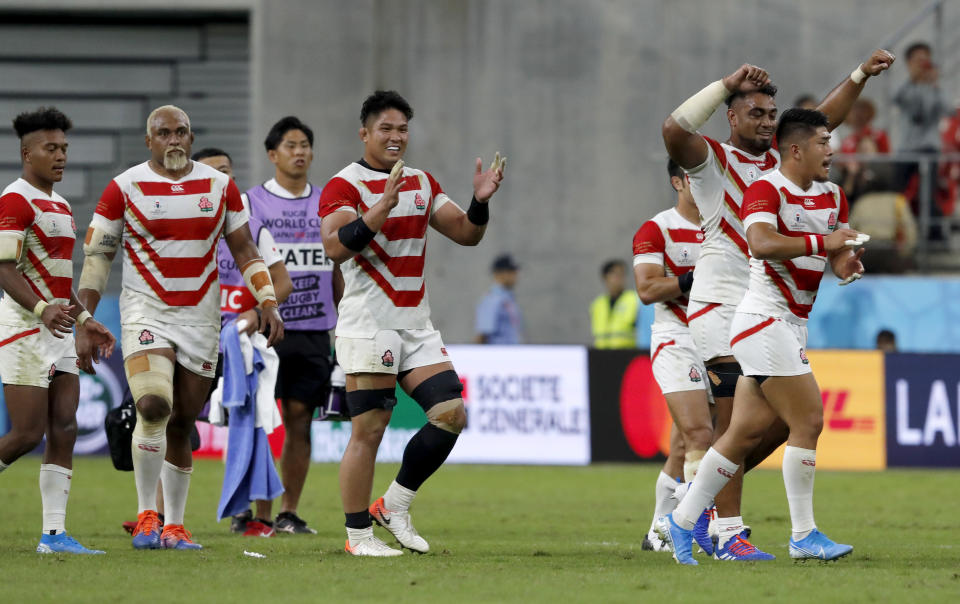 Japan players celebrate after their Rugby World Cup Pool A game at City of Toyota Stadium against Samoa in Tokyo City, Japan, Saturday, Oct. 5, 2019. Japan defeated Samoa 38-19.(AP Photo/Shuji Kajiyama)