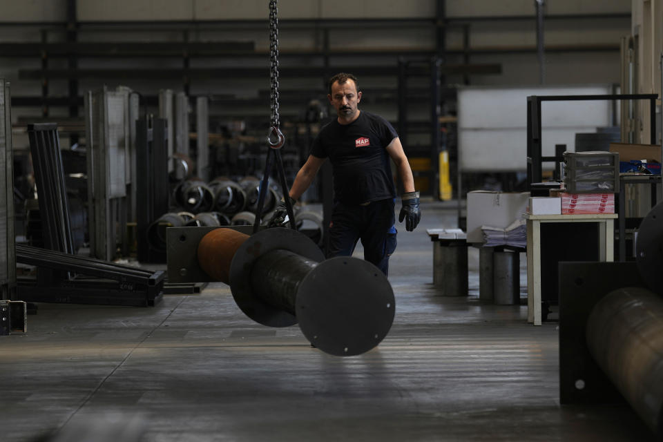 A man works at MAP, a factory operating in design, manufacture and installation of steel structures for civil and industrial use, in Corsico, near Milan, Italy, Thursday, May 12, 2022. Russia's war in Ukraine has accelerated inflation across Europe, with prices for energy, materials and food surging at rates not seen for decades. Inflation is expected to hit nearly 7% this year in the 27-nation EU and is contributing to slowing growth forecasts. (AP Photo/Antonio Calanni)