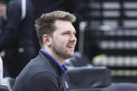 Dallas Mavericks guard Luka Doncic watches warmups in street clothes prior to an NBA basketball game against the Utah Jazz, Saturday, Jan. 28, 2023, in Salt Lake City. (AP Photo/Rob Gray)