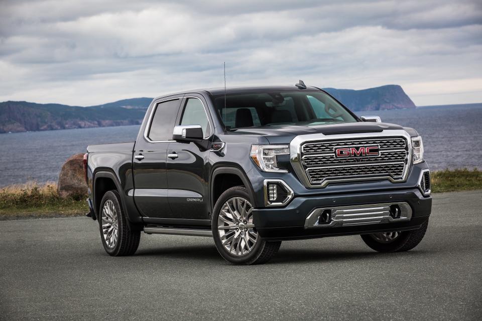 A black 2020 GMC Sierra Denali truck against a mountain backdrop.