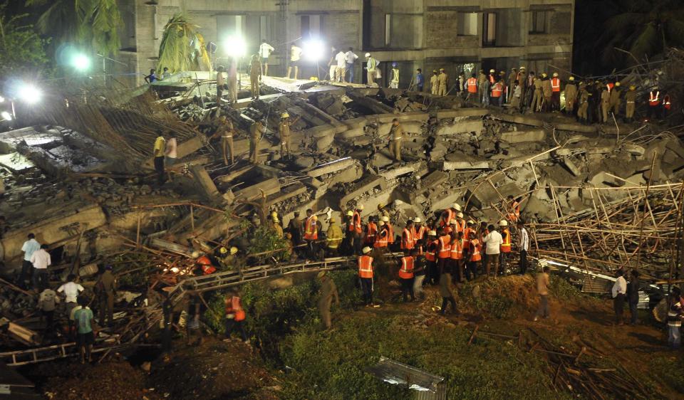 Rescue workers conduct a search operation for survivors at the site of a collapsed 11-storey building that was under construction on the outskirts of the southern Indian city of Chennai