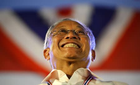 Protest leader Suthep Thaugsuban smiles as he prepares to address anti-government protesters as they take part in birthday celebrations for Thailand's King Bhumibol Adulyadej, at the occupied government complex in Bangkok in this December 5, 2013 file photo. REUTERS/Dylan Martinez/Files