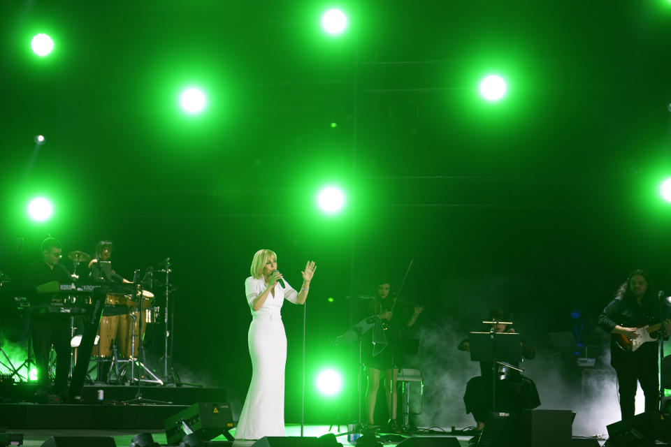 Iranian pop star Googoosh performs during a concert at the Dubai Expo 2020, in Dubai, United Arab Emirates, Thursday, March 17, 2022. Iranian pop diva and national icon Googoosh delivered old hits and songs from her new album to a packed stadium on Thursday in Dubai — just across the Persian Gulf from her home that had banned her from singing for 21 years and where authorities to this day continue to protest her performances. (AP Photo/Ebrahim Noroozi)