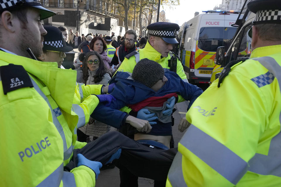 Police arrest protesters of the climate campaigners group Just Stop Oil outside Downing Street in London, Thursday, Nov. 23, 2023. Britain is one of the world's oldest democracies, but some worry that essential rights and freedoms are under threat. They point to restrictions on protest imposed by the Conservative government that have seen environmental activists jailed peaceful but disruptive actions. (AP Photo/Frank Augstein)