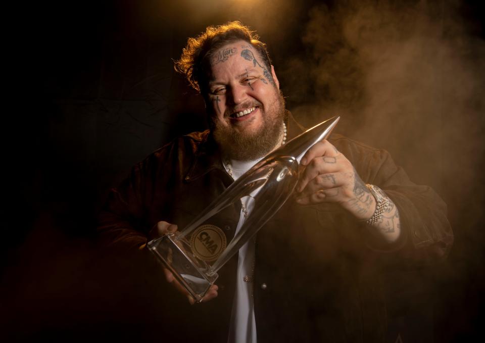 Jelly Roll stands backstage holding his CMA award at Bridgestone Arena in Nashville, Tenn., Wednesday, Nov. 8, 2023. Jelly Roll told the Tennessean, “There’s a tale of two Nashville, that’s happening with me right now. Nashville the music industry that has embraced me so lovingly but I represent equally the Nashville I grew up in as a local.”