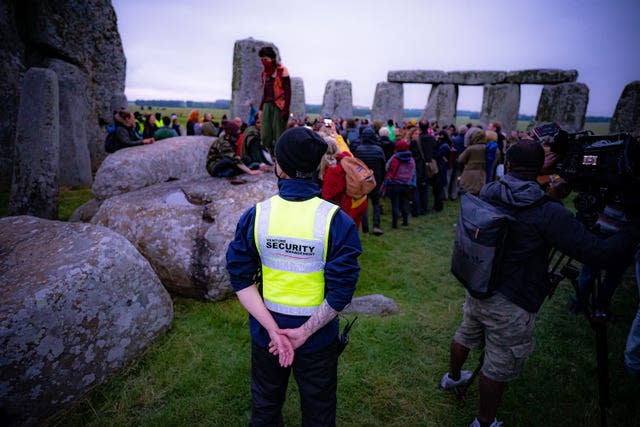 Security guards watch the crowds celebrate