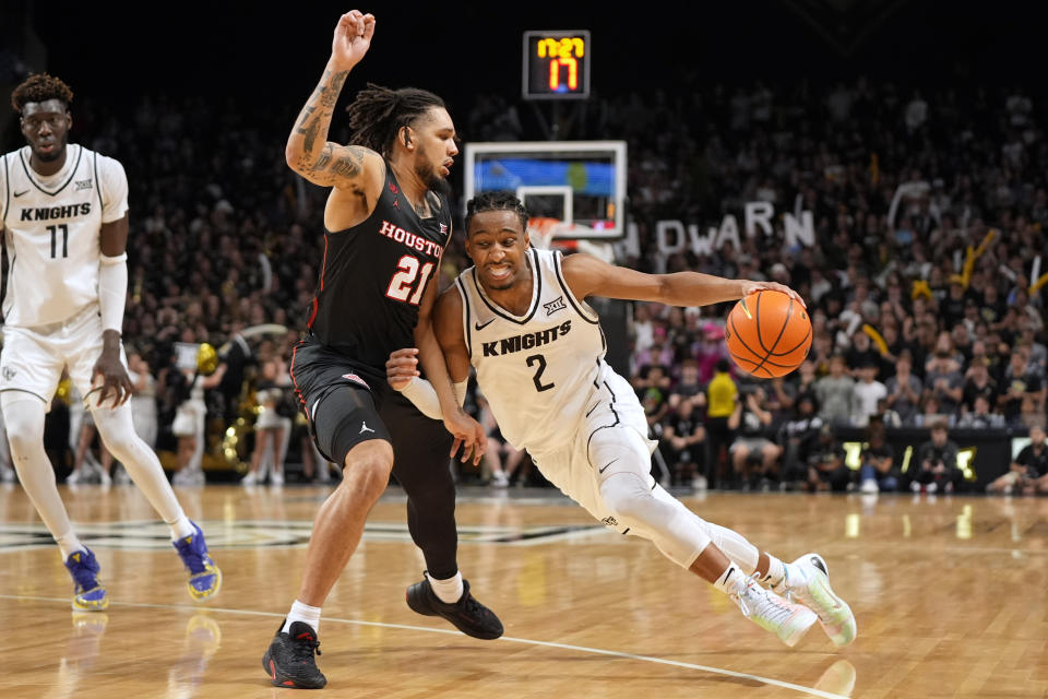 Central Florida guard Shemarri Allen (2) drives around Houston guard Emanuel Sharp (21) during the second half of an NCAA college basketball game Wednesday, March 6, 2024, in Orlando, Fla. (AP Photo/John Raoux)