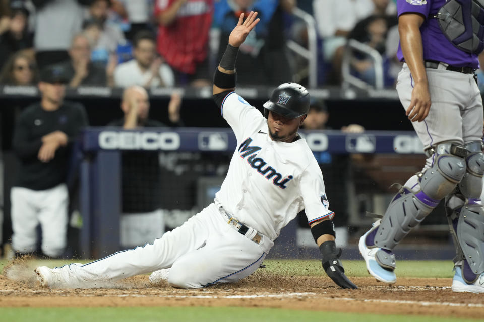 Miami Marlins' Luis Arraez scores on a sacrifice fly by Yuli Gurriel in the sixth inning of a baseball game against the Colorado Rockies, Sunday, July 23, 2023, in Miami. (AP Photo/Marta Lavandier)