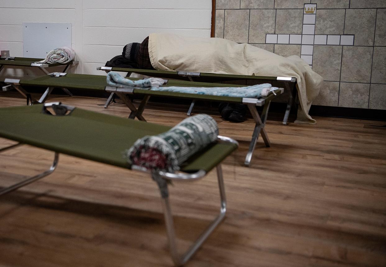 A man sleeps at ABCCM’s emergency shelter in East Asheville November 22, 2022.