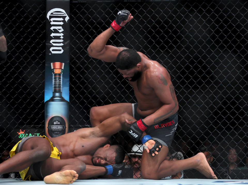 Mar 9, 2024; Miami, Florida, USA; Jailton Almeida (blue gloves) fights Curtis Blaydes (red gloves) during UFC 299 at Kayesa Center. Mandatory Credit: Sam Navarro-USA TODAY Sports