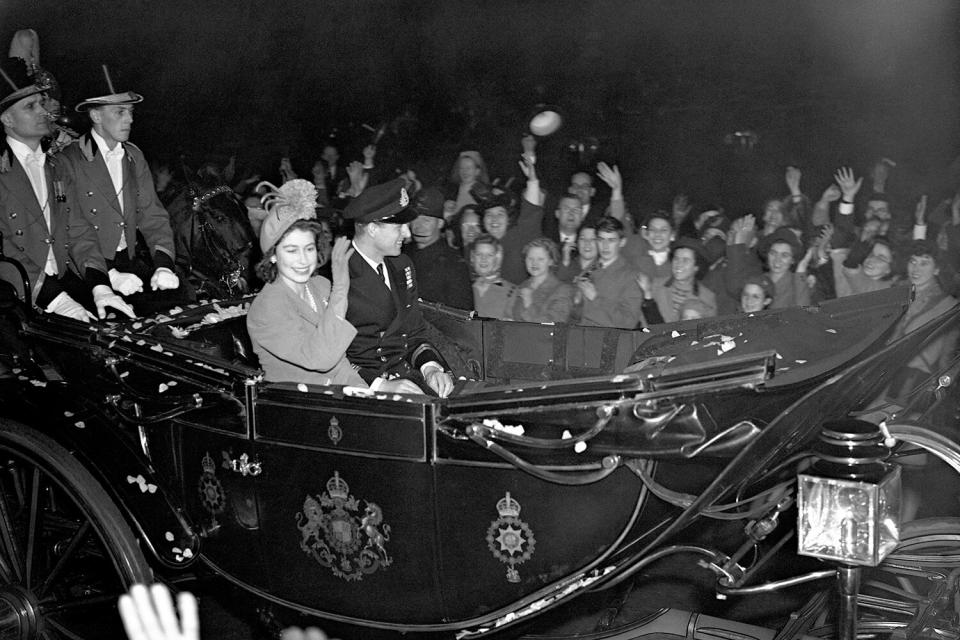 Princess Elizabeth and the Duke of Edinburgh in a carriage procession to Waterloo Station for their train to Winchester for the start of their honeymoon.