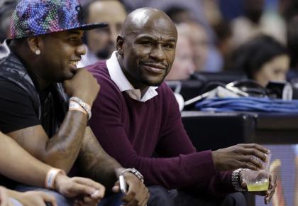 Mayweather gets the full celebrity treatment when he attends NBA games. (AP) 