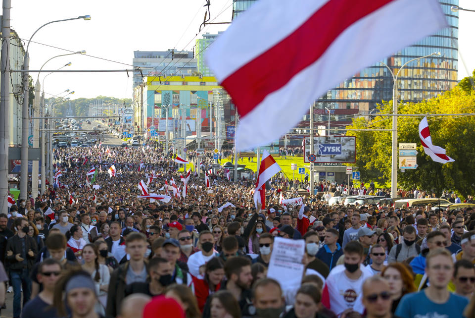 Protesters with old Belarusian national flags march during an opposition rally to protest the official presidential election results in Minsk, Belarus, Sunday, Sept. 20, 2020. Protests calling for the authoritarian president's resignation broke out after an Aug. 9 election that officials say gave him a sixth term in office and that opponents say was rigged. (AP Photo/TUT.by)