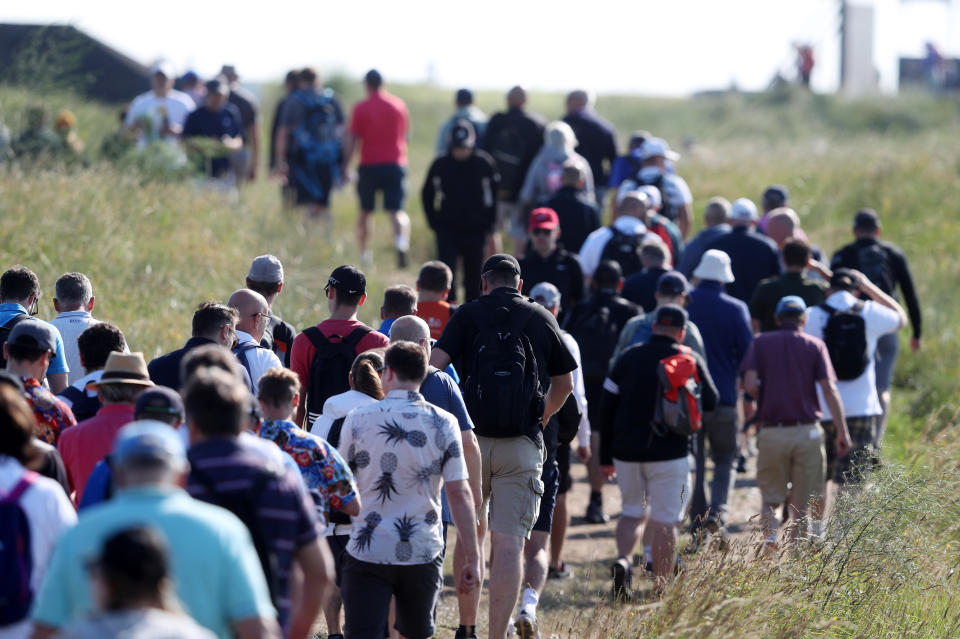 <p>Spectators walk the course during day one of The Open at The Royal St George's Golf Club in Sandwich, Kent. Picture date: Thursday July 15, 2021.</p>
