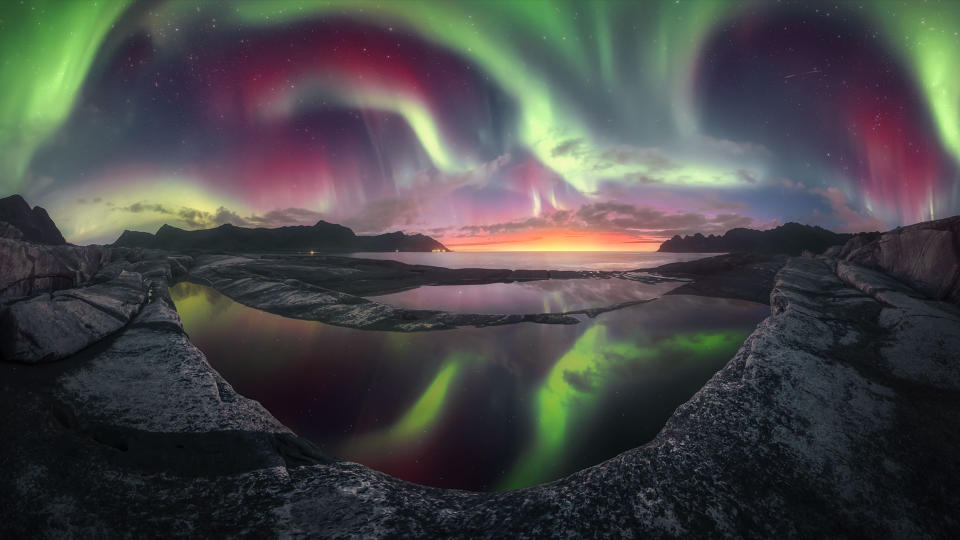 Purple, orange and green northern lights over Senja Island, Norway.