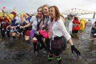 EDINBURGH, SCOTLAND - JANUARY 01: Over 1000 New Year revellers, many in fancy dress, braved freezing conditions in the River Forth in front of the Forth Rail Bridge during the annual Loony Dook Swim on January 1, 2012 in South Queensferry, Scotland. Thousands of people gathered last night to see in the New Year at Hogmanay celebrations in towns and cities across Scotland. (Photo by Jeff J Mitchell/Getty Images)