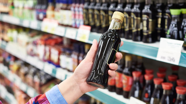 Costco shopper holding sauce bottle