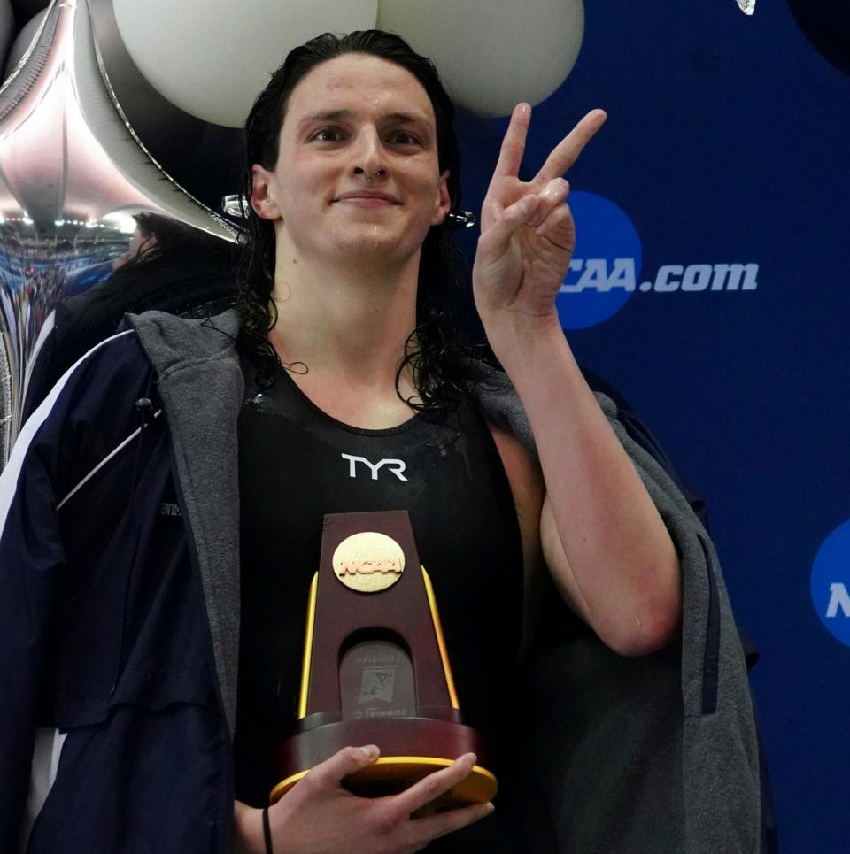 Lia Thomas on the podium with her trophy for winning the 500-yard freestyle in Atlanta - AP Photo/John Bazemore