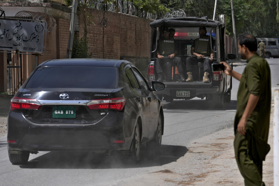 A police squad escort a car carrying a judge of special court leaving after a case hearing of Pakistan's former Prime Minister Imran Khan at the District Jail, in Attock, Pakistan, Wednesday, Aug. 30, 2023. A court asked the official in charge of the Attock prison to keep former Prime Minister Khan there until at least Wednesday, when Khan is expected to face a hearing on charges of "exposing an official secret document" in an incident last year when he waved a confidential diplomatic letter at a rally. The Islamabad High Court on Tuesday suspended the corruption conviction and three-year prison term of him, his lawyers and court officials said. (AP Photo/Anjum Naveed)